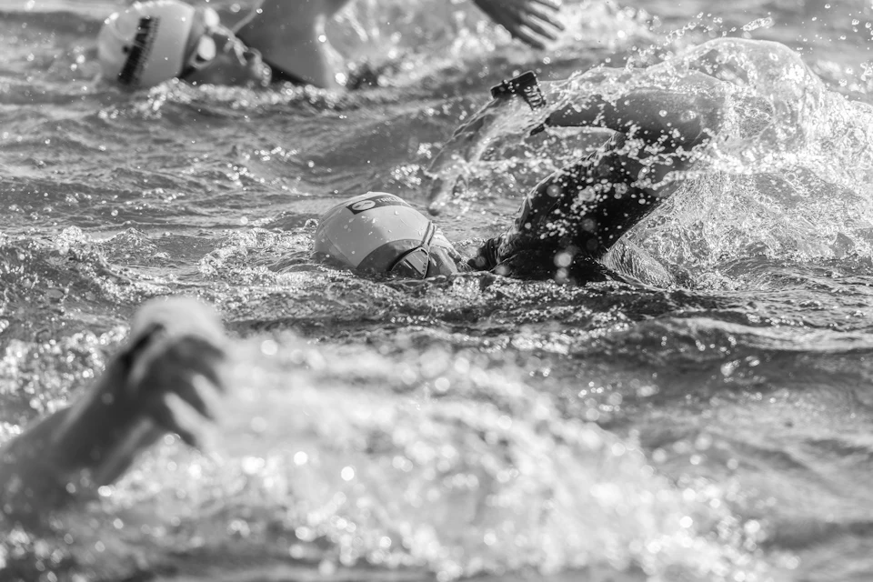 Nadadores en plena salida de un triatlón, en blanco y negro